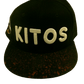 BLACK SPLASH SNAPBACK featuring a black kitos hat with a custom brim and gold accents.